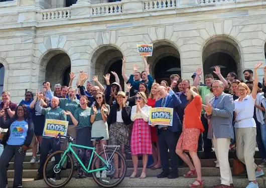 People celebrating on the steps of the MN Capitol