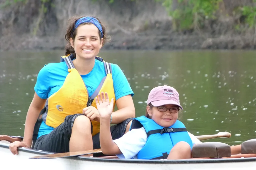 A young woman and a girl in a canoe on the river